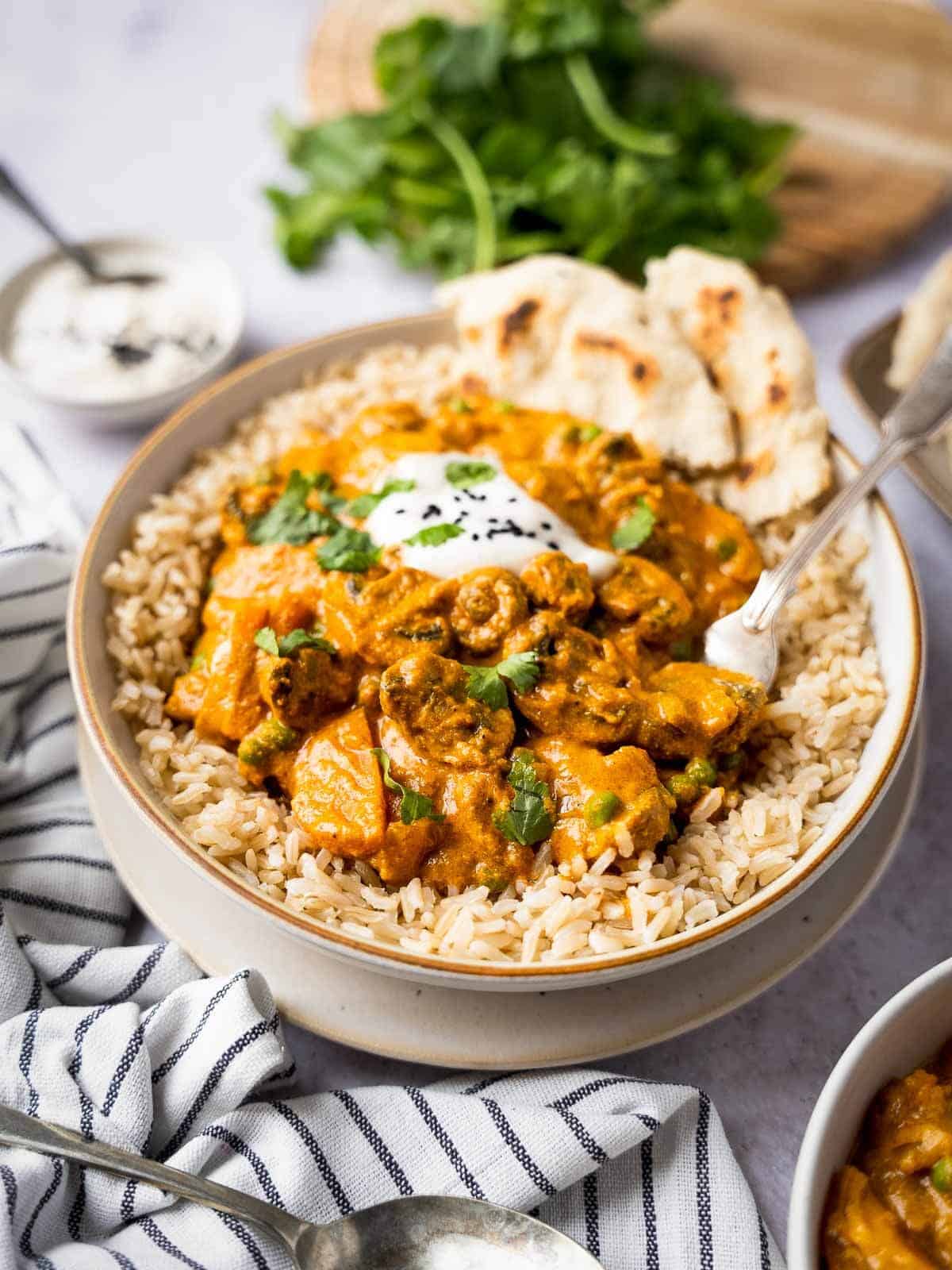 vegetable tikka masala curry with a dollop of coconut yogurt, sesame seeds, and brown rice.