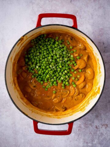 add green peas on top of the cooked curry.