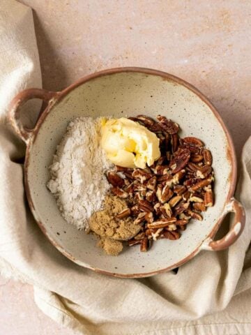 bowl with gluten-free flour, butter, pecans, and brown sugar.