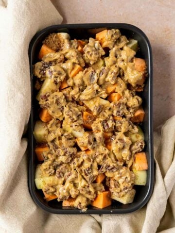 sweet potato and apple dice in casserole dish covered with pecan mixture before baking.