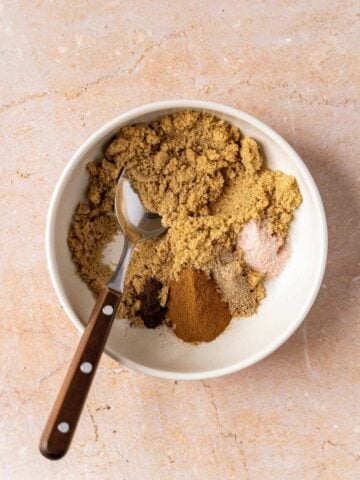 crumble ingredients in bowl with a spoon.