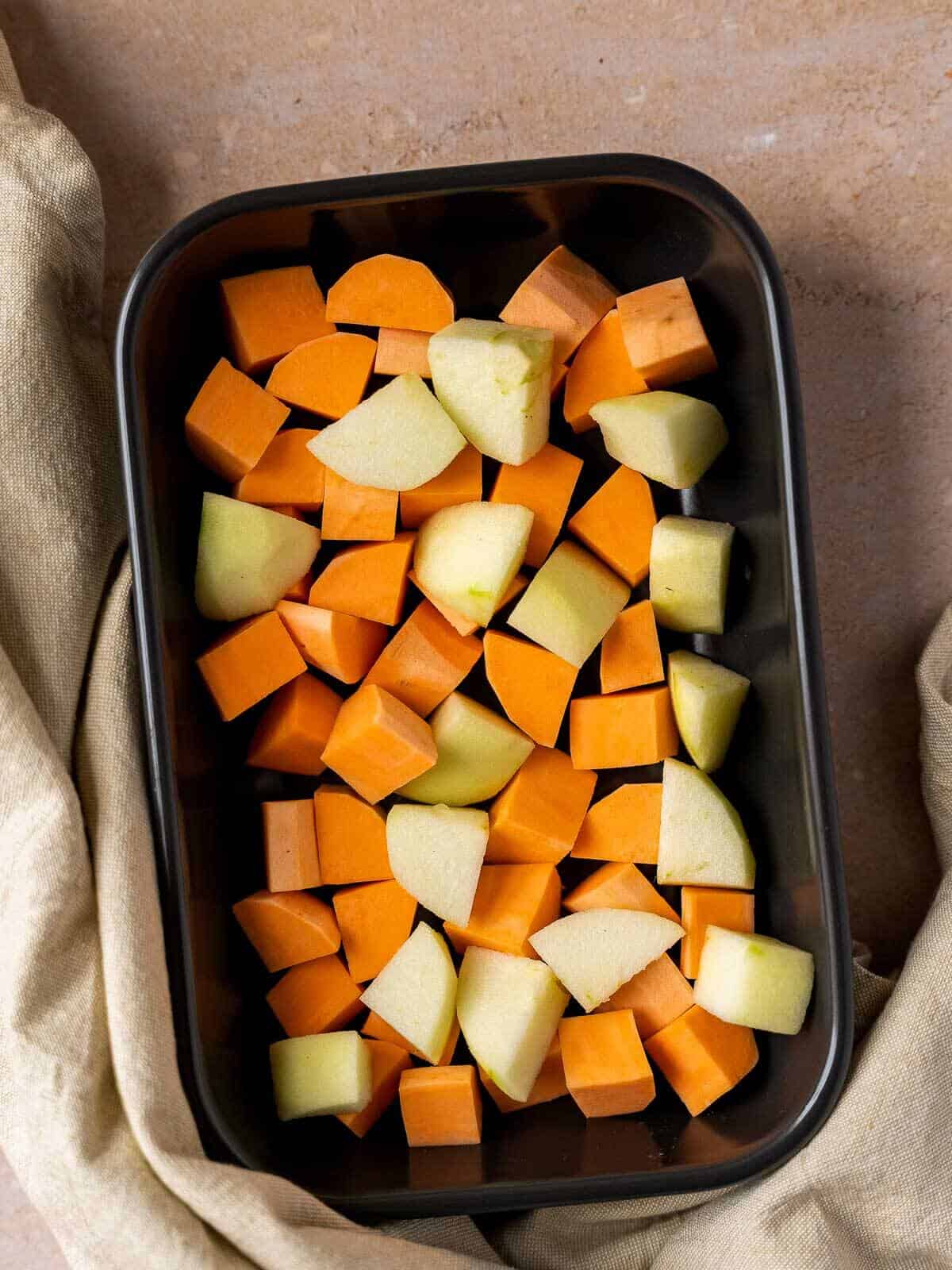 casserole dish with apple and sweet potato dice.