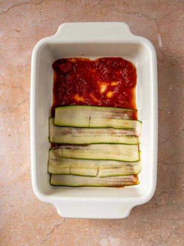 add zucchini slices on top of the marinara sauce.