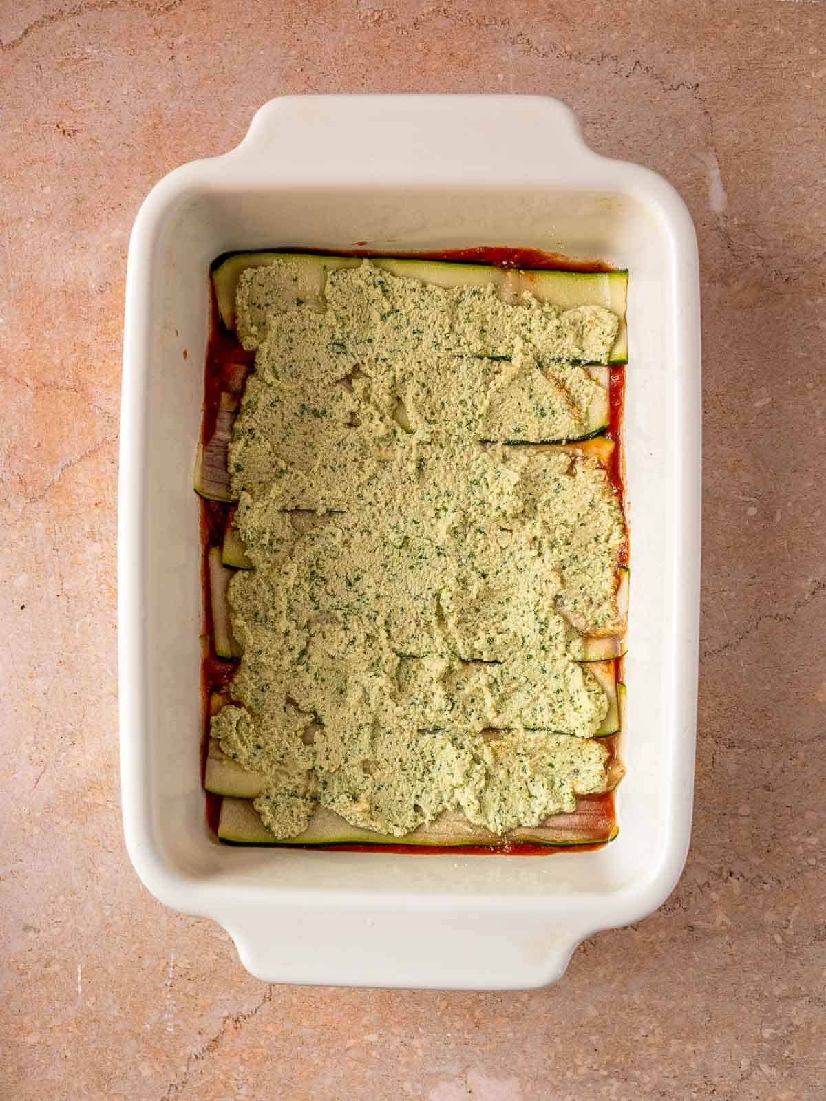 spread vegan tofu ricotta on top of zucchini slices.