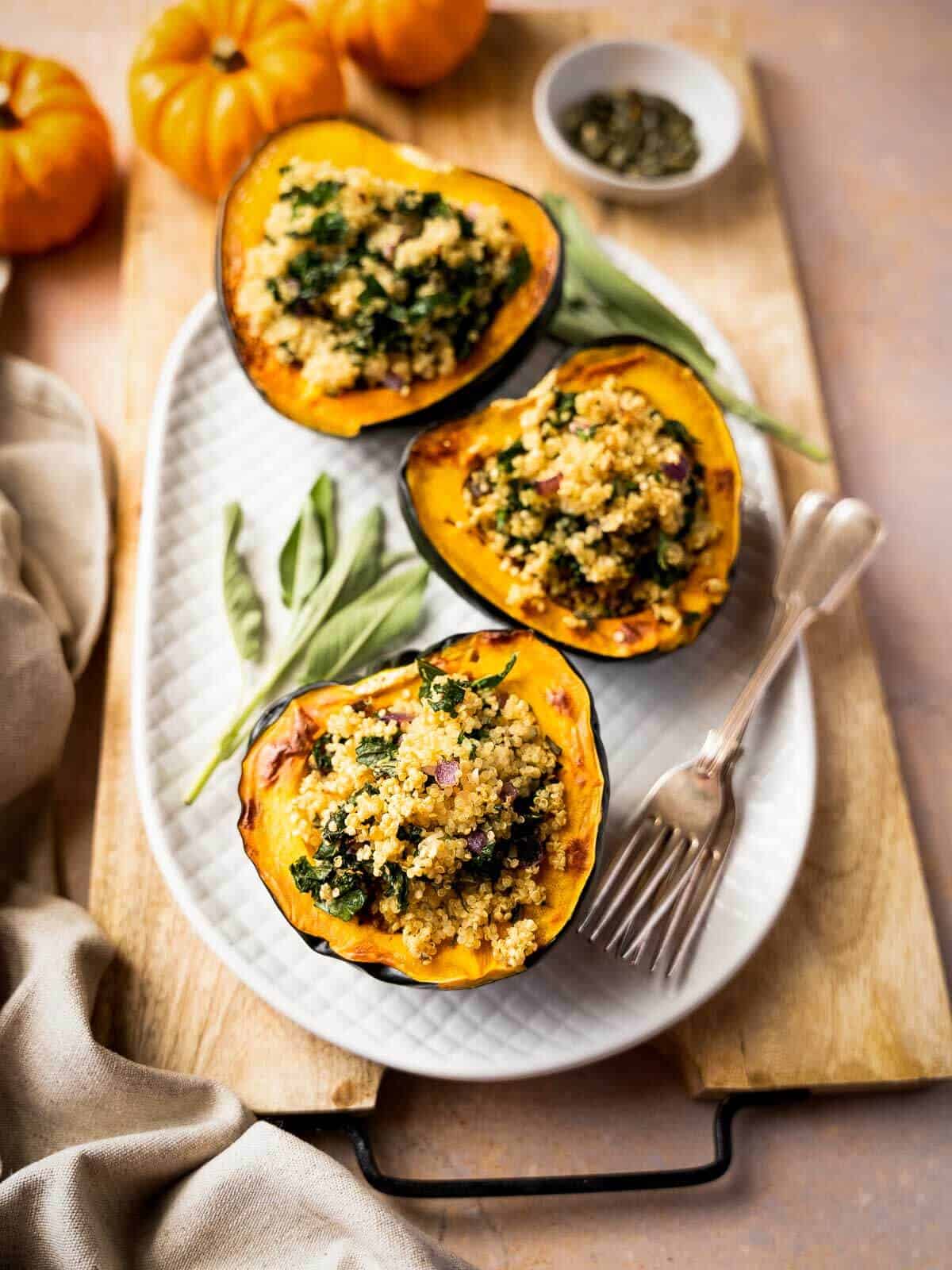 stuffed acorn squash served on a wooden table.