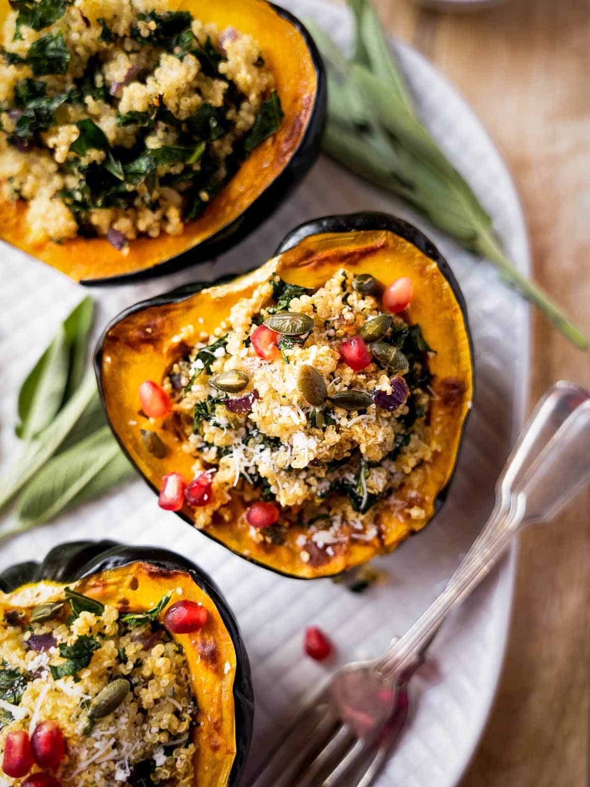close up of stuffed acorn squash with pomegranate seeds.
