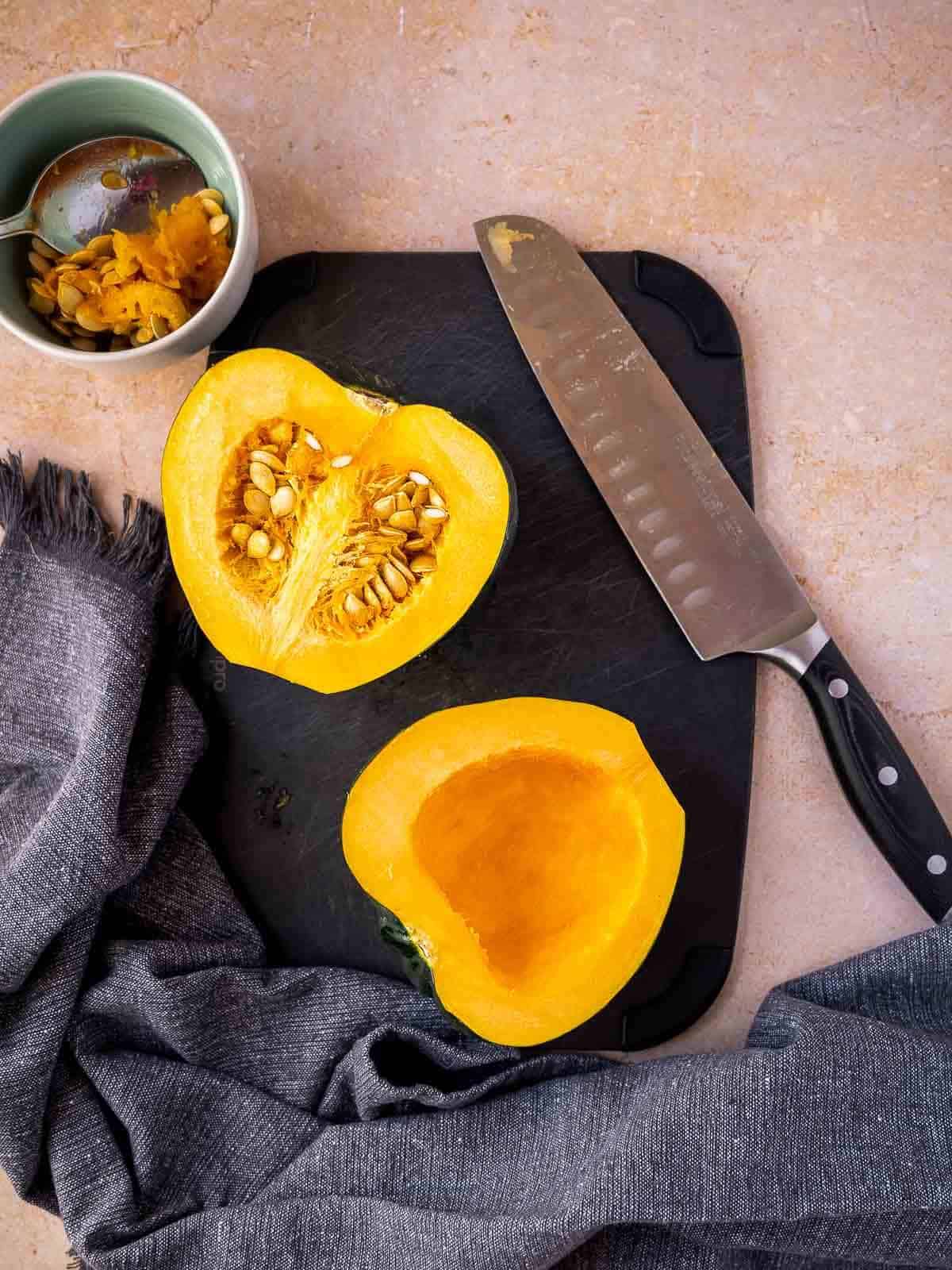cut the acorn squash in half and remove the seeds.