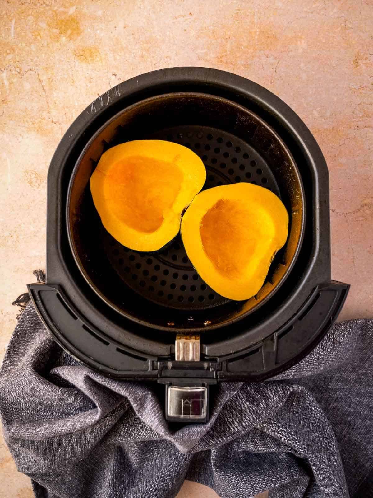 put the acorn squash face up in the air fryer.