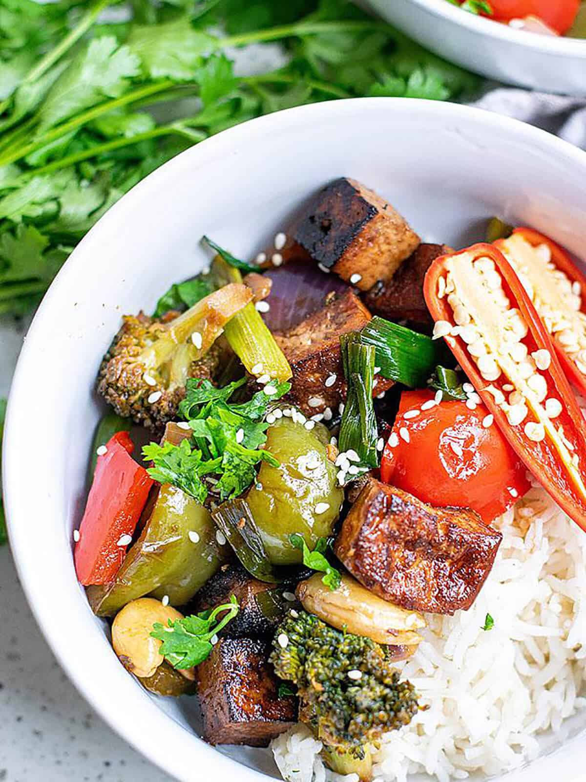 kung pao tofu recipe served in a bowl with steamed rice.