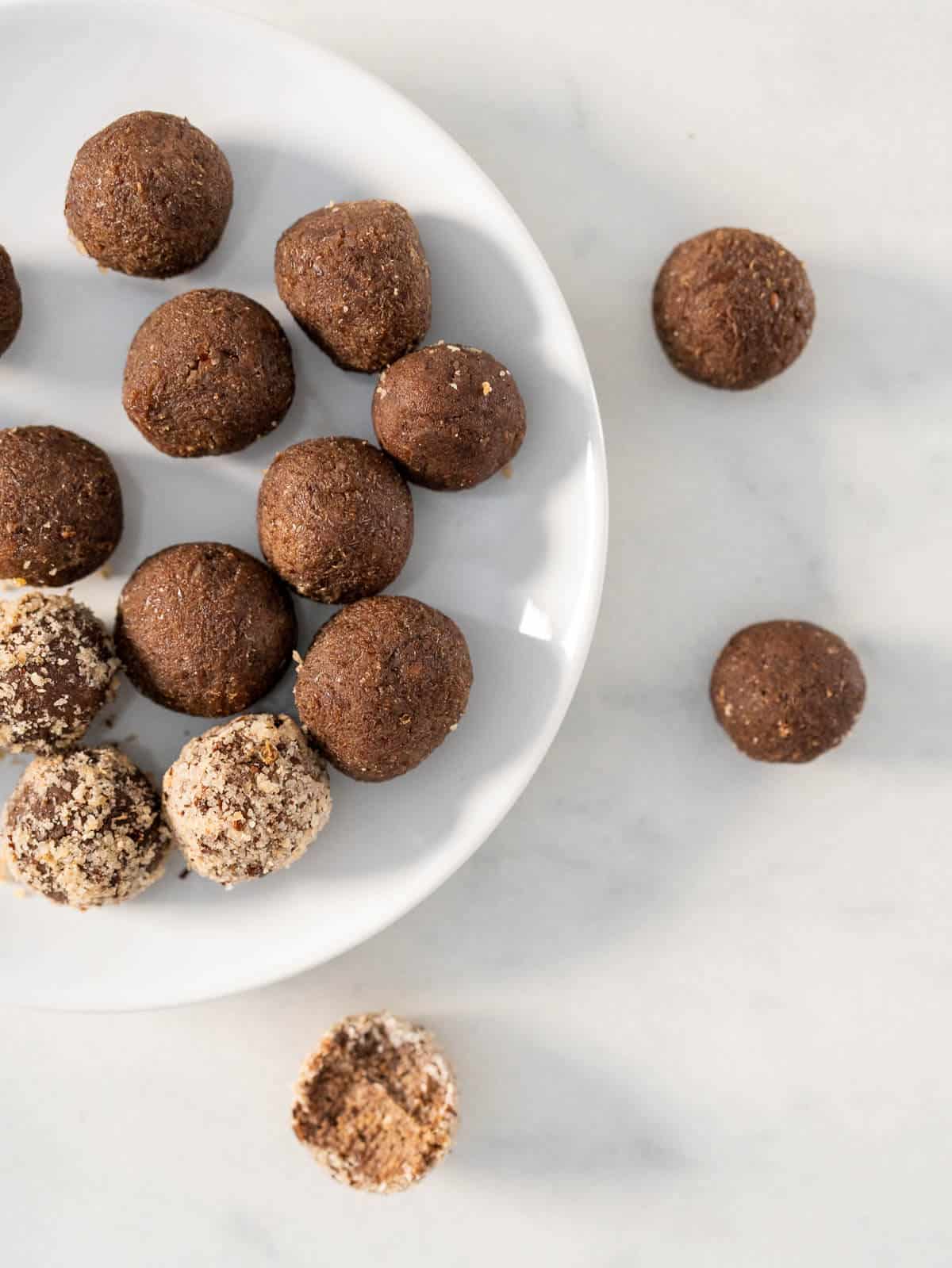 3-ingredient low calorie vegan protein balls, chocolate flavored, in a white serving plate.