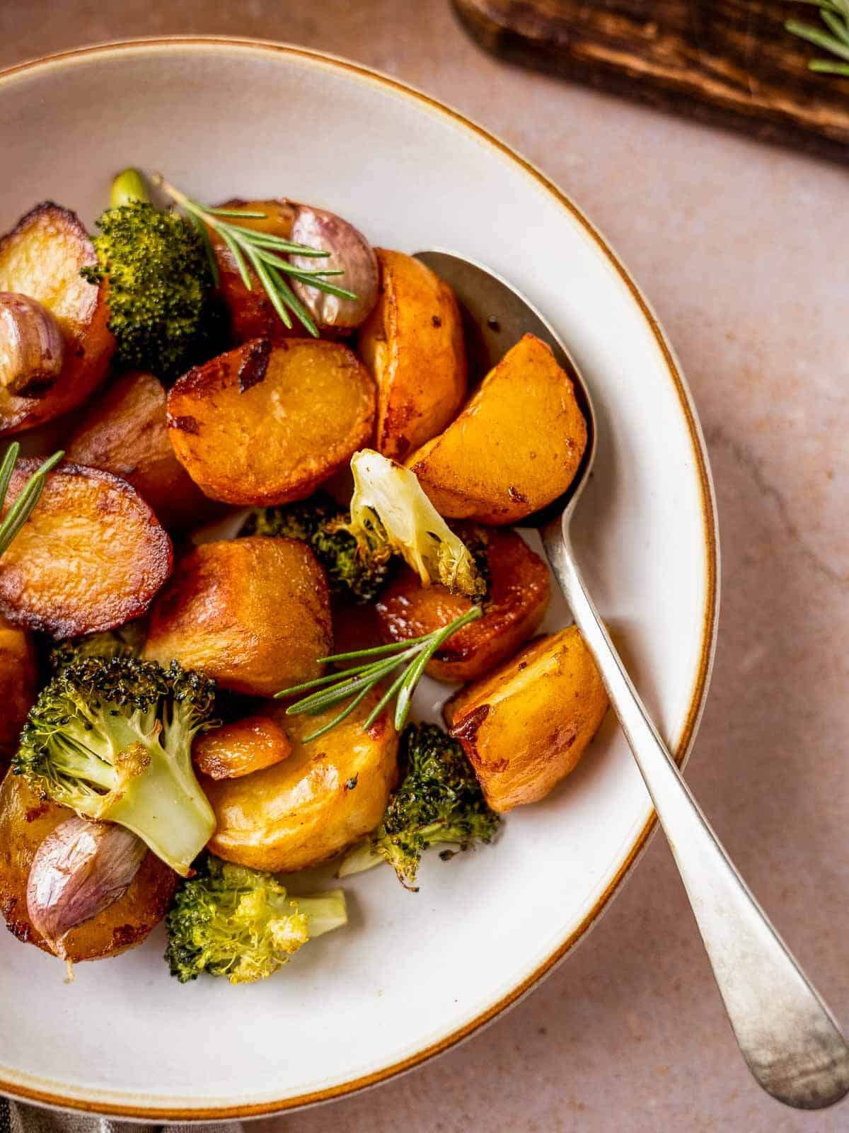 roasted garlic and rosemary potatoes with marmite plated in white plate.