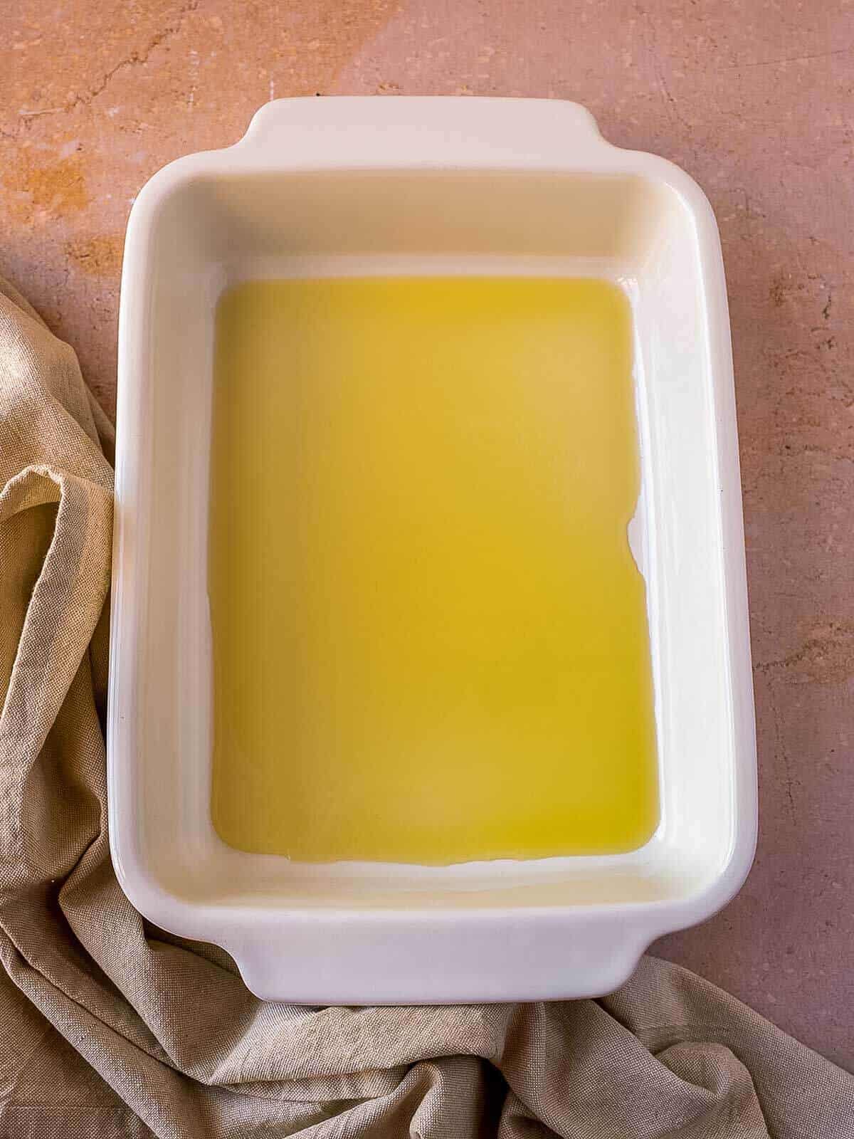 heat olive oil in a baking dish.