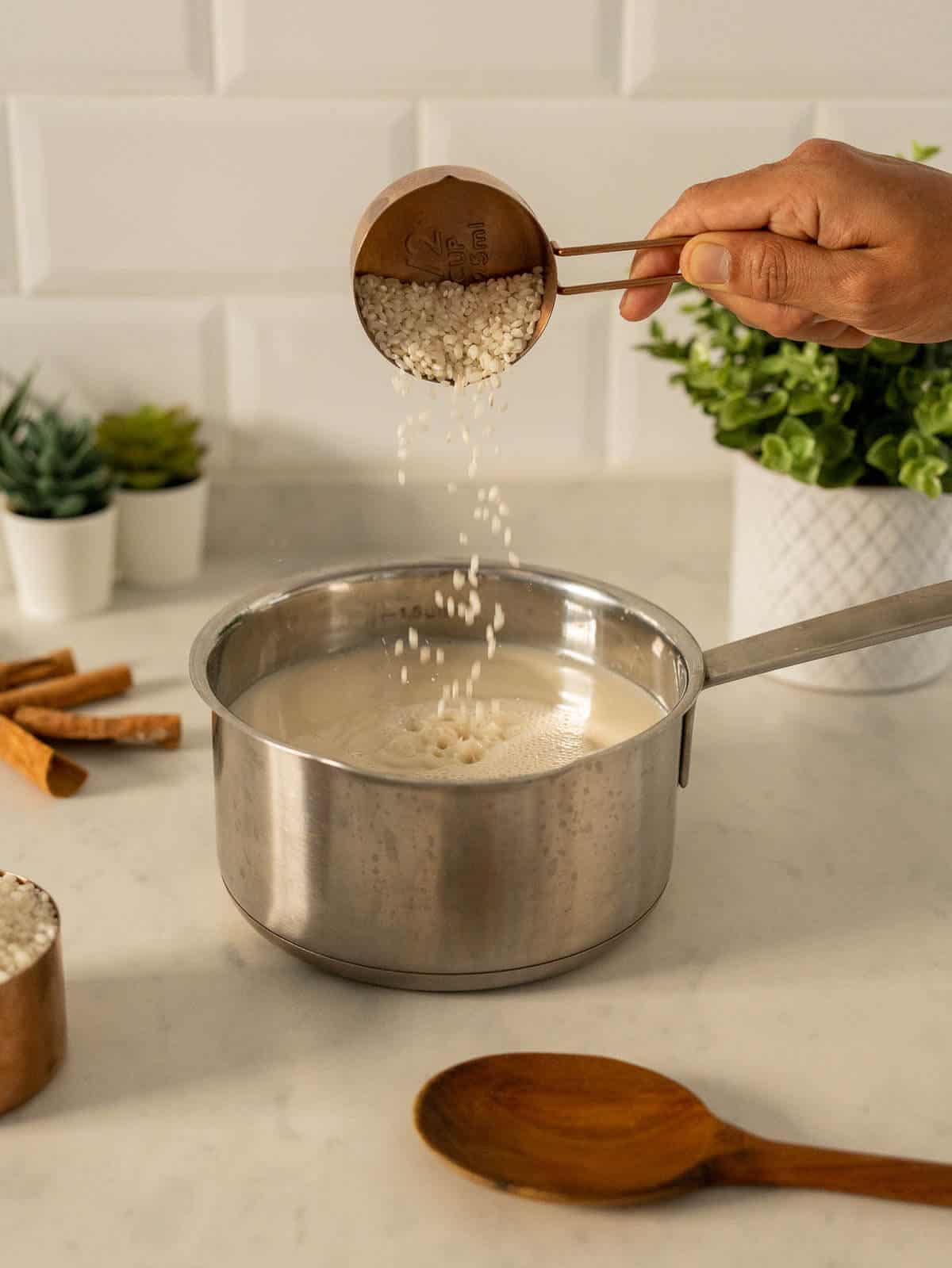 adding rice to the saucepan.
