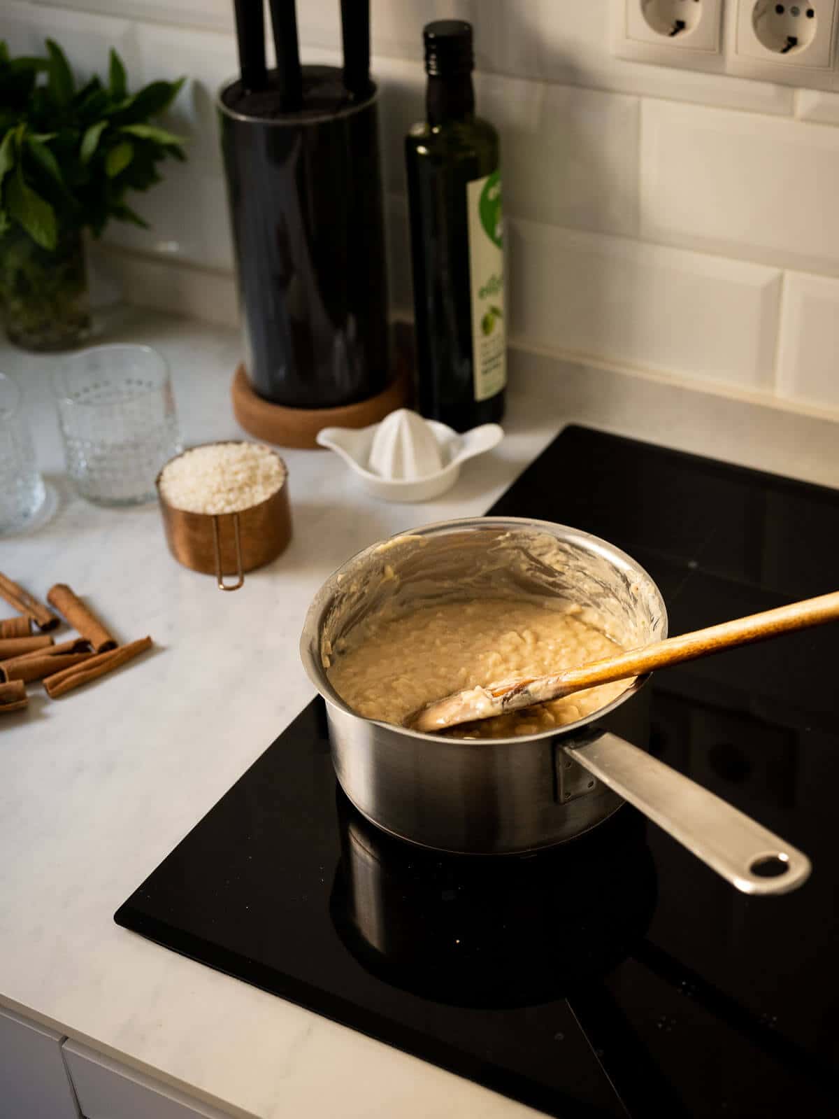 pot with rice pudding and a wooden spoon.