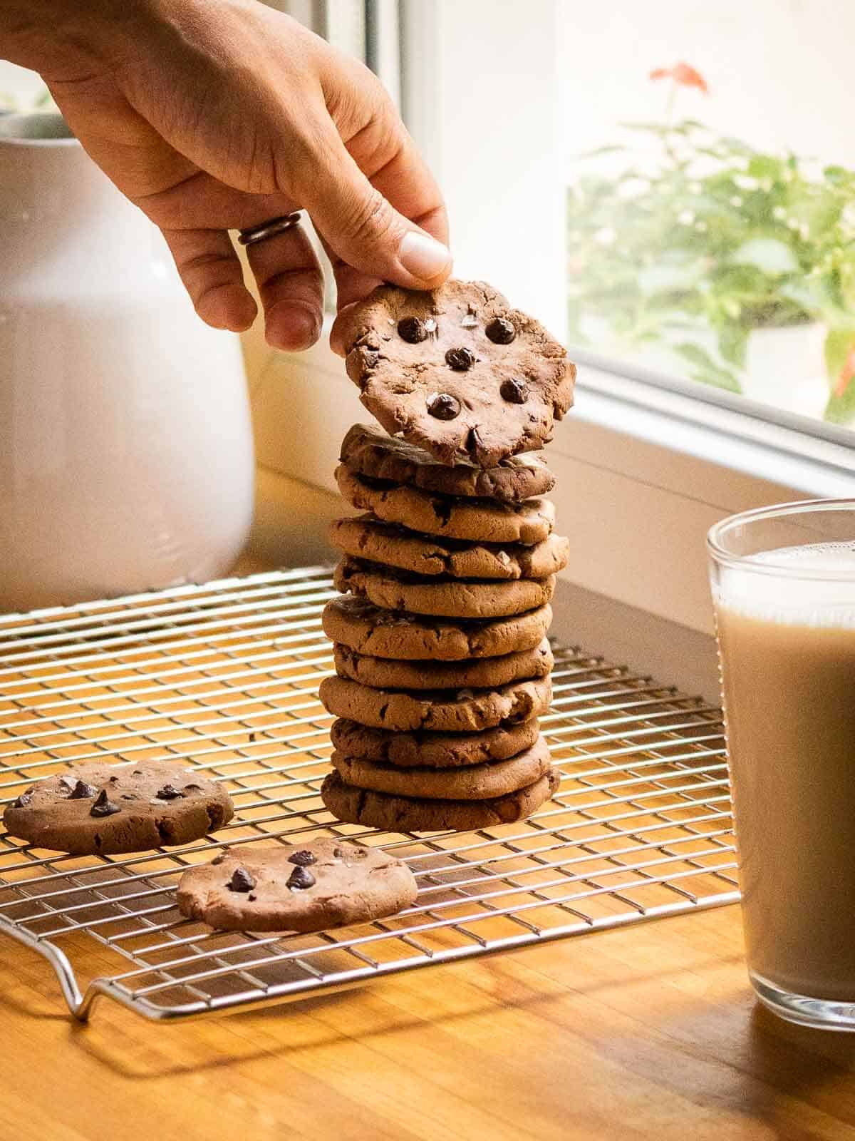hand picking a cookie from cookies tower.