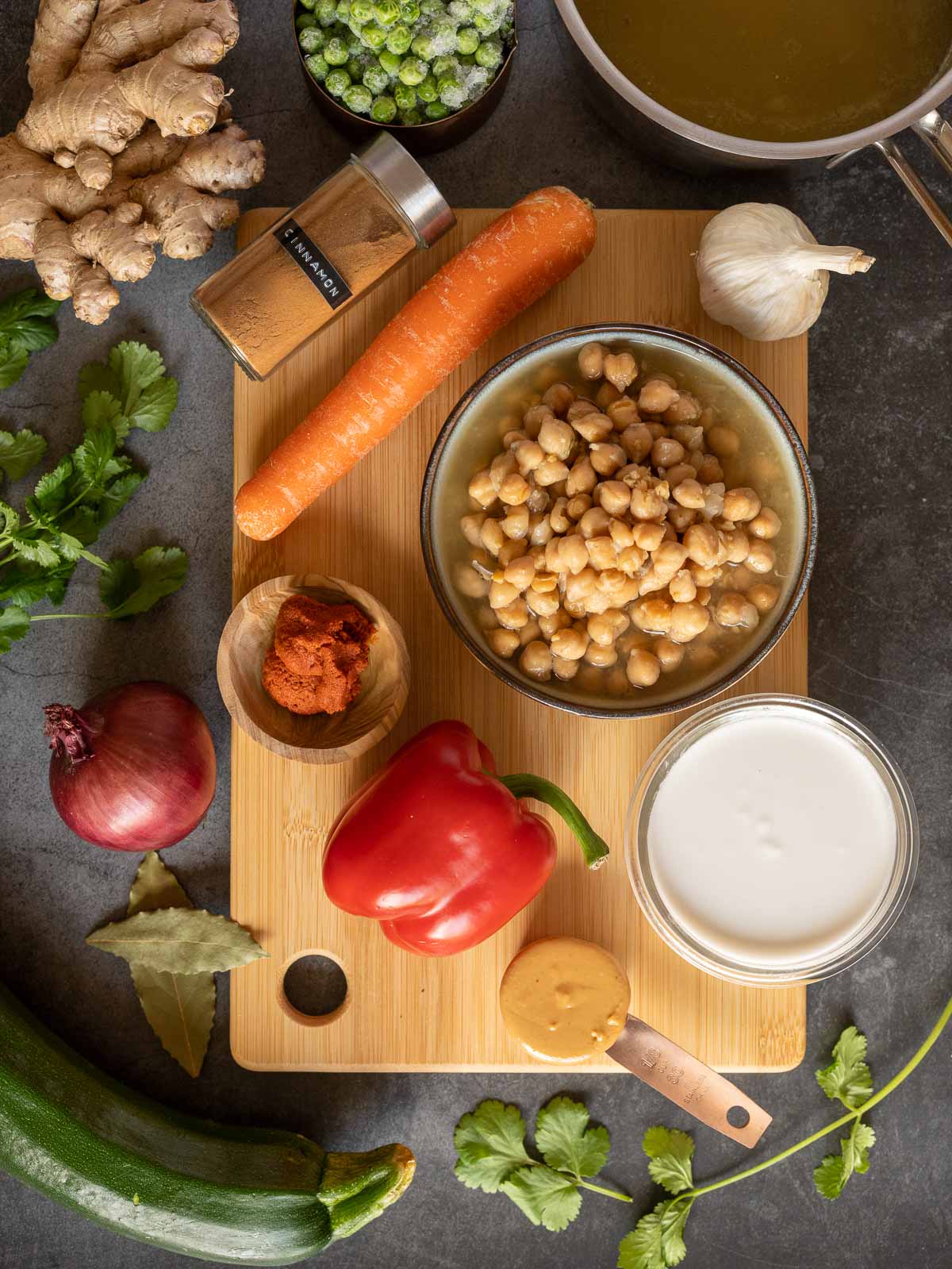 ingredients to make vegan coconut chickpea curry on a wooden table.
