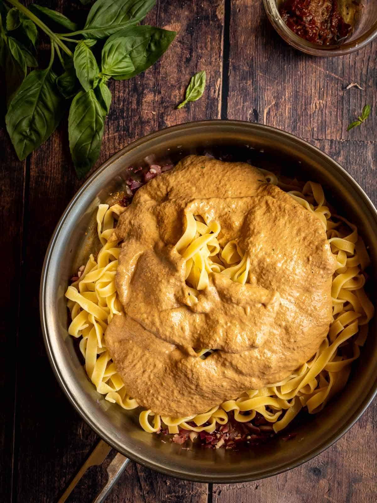 fettuccine on a pan with rose sauce on top.