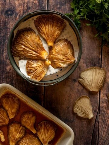 place marinated mushrooms in the air fryer basket.