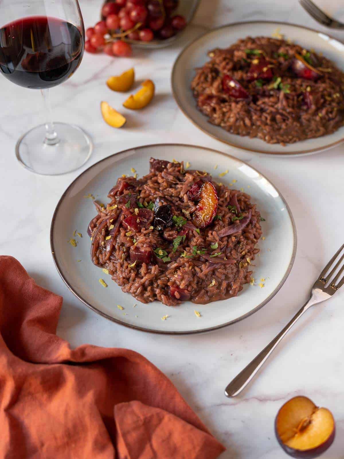two plates served with red wine risotto.