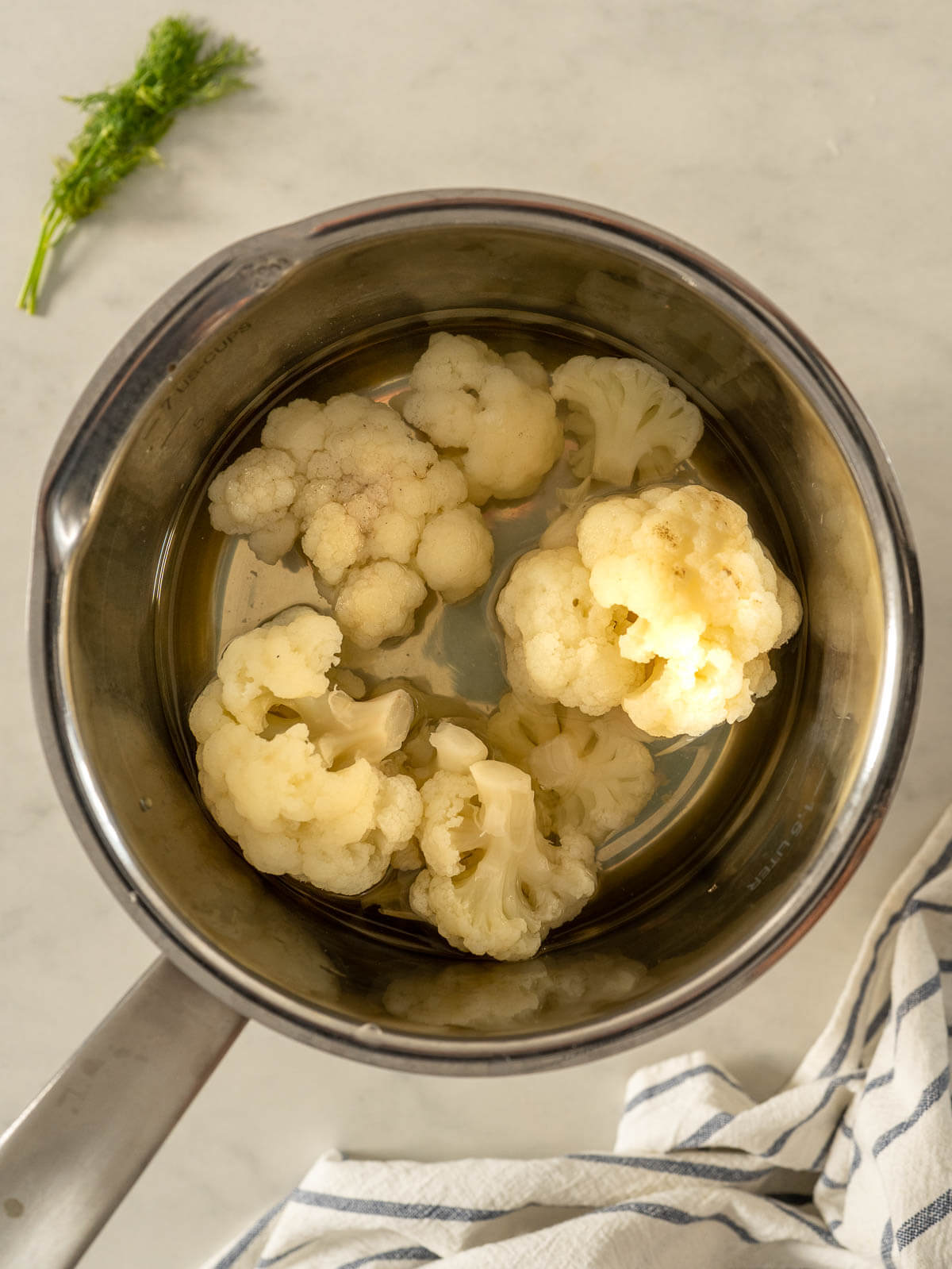 saucepan with boiling water and cauliflower florets.