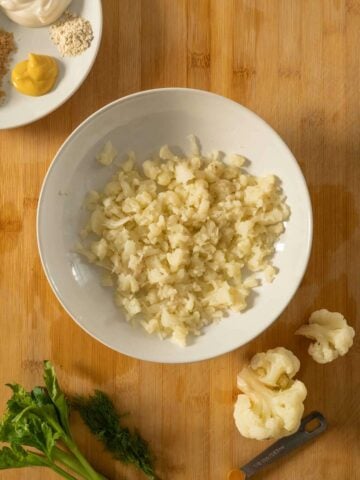 plate with broken cauliflower florets into tiny pieces.