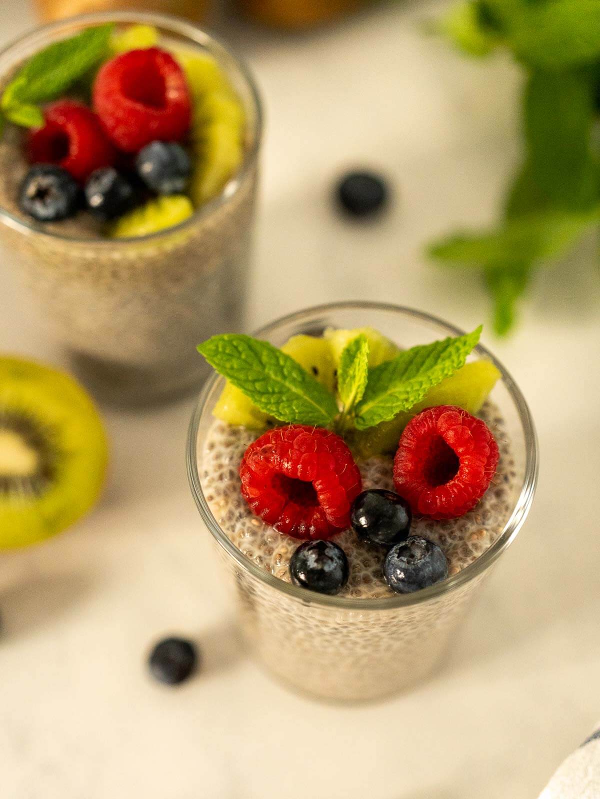upper view of garnished portions of oat milk chia puddings.