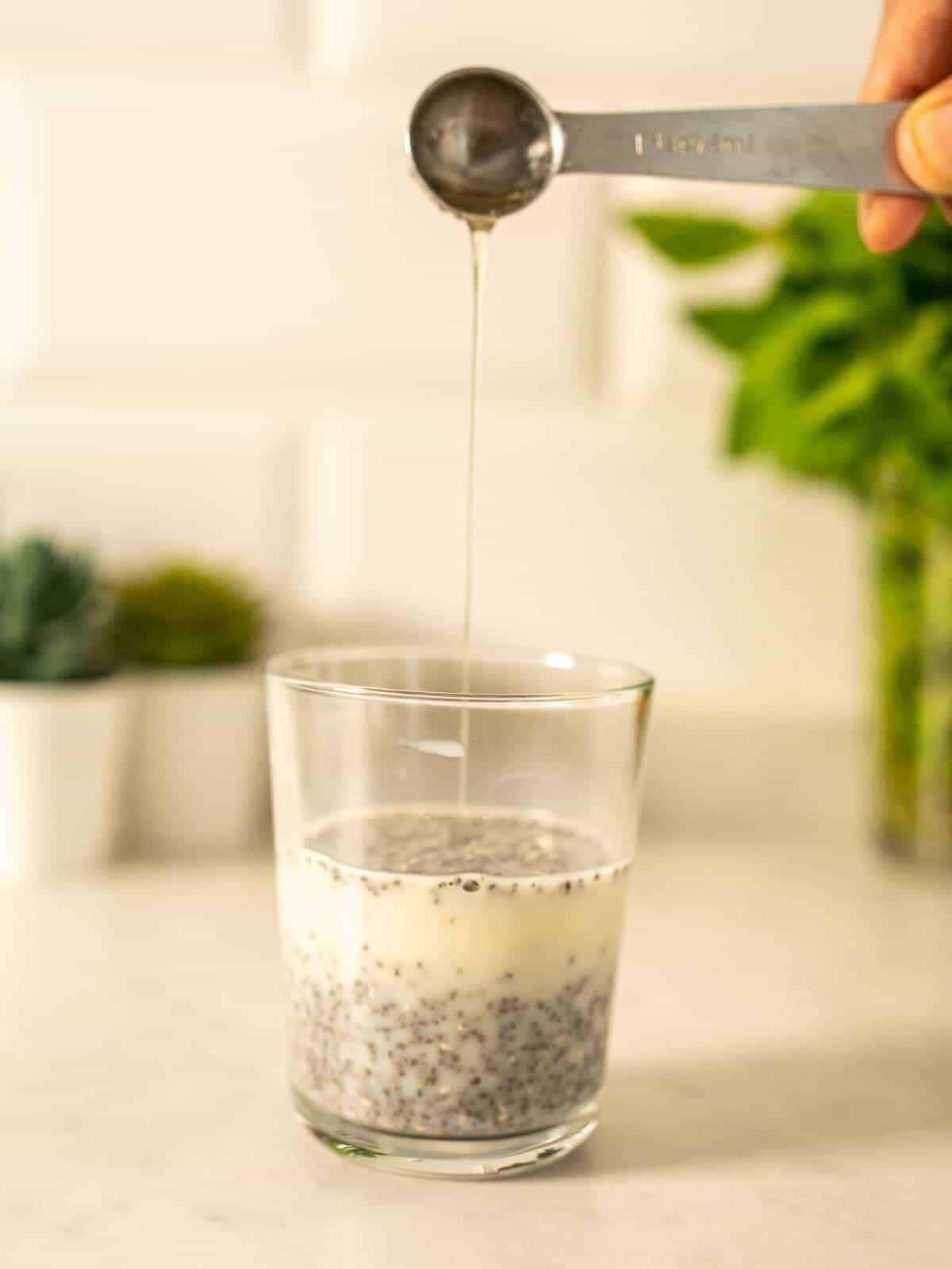 adding measured sweetener into a glass.
