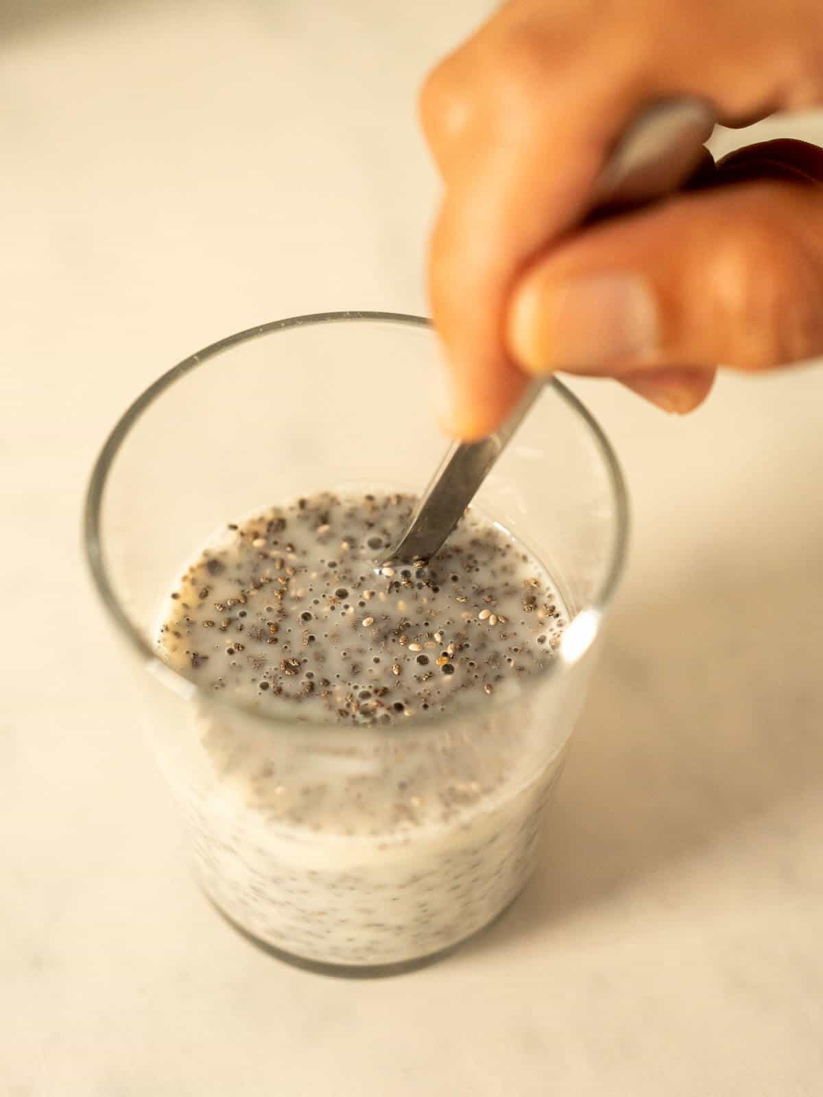 stir the chia seeds in the oat milk with a teaspoon.