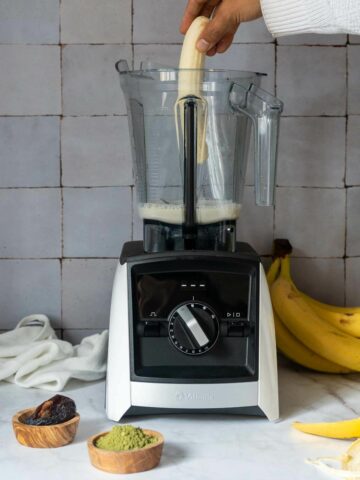 add the plant milk and banana to the blender.