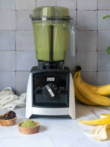 blender with all the matcha smoothie ingredients in the jar.