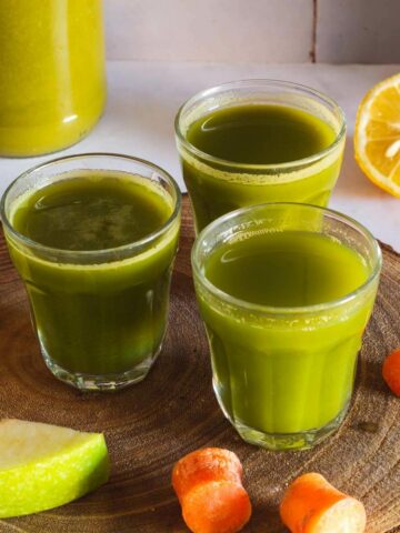 three apple lemon carrot spinach juice shots featured.