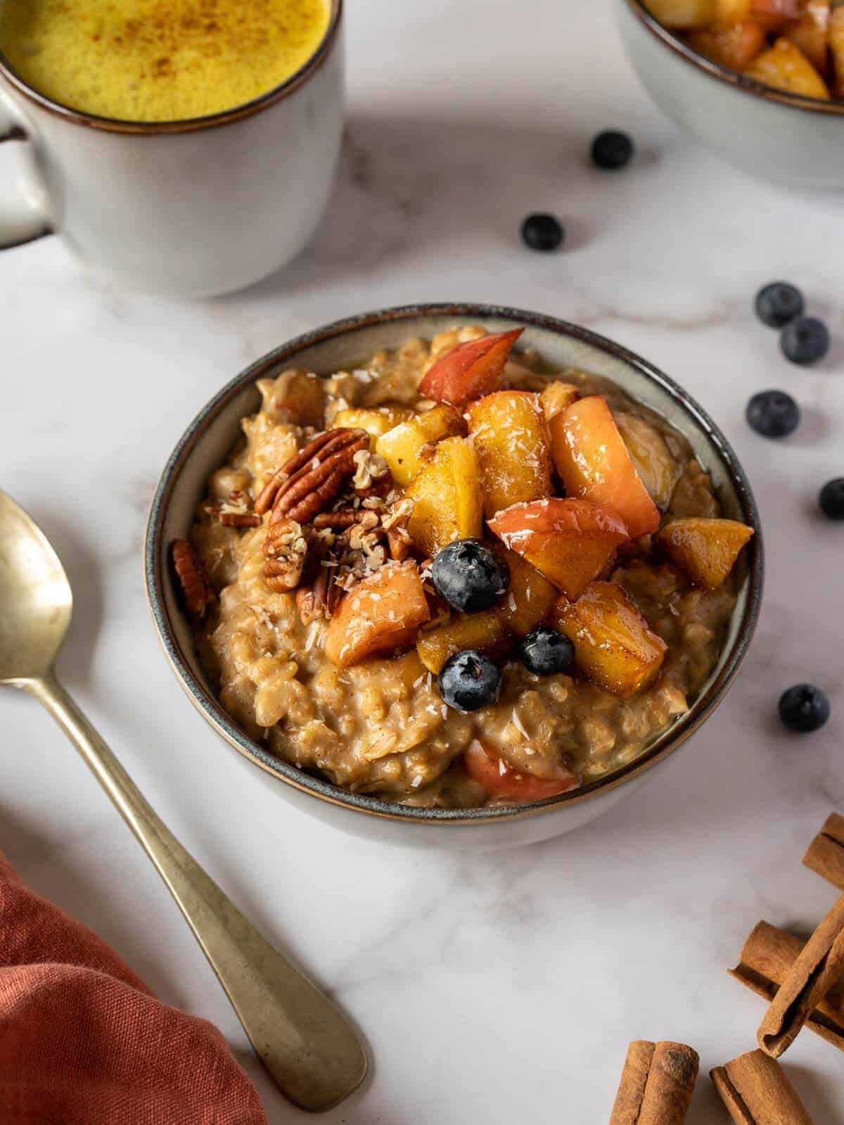 garnish the oatmeal bowl with the remaining chopped apples, nuts, shredded coconut, and fresh fruit.