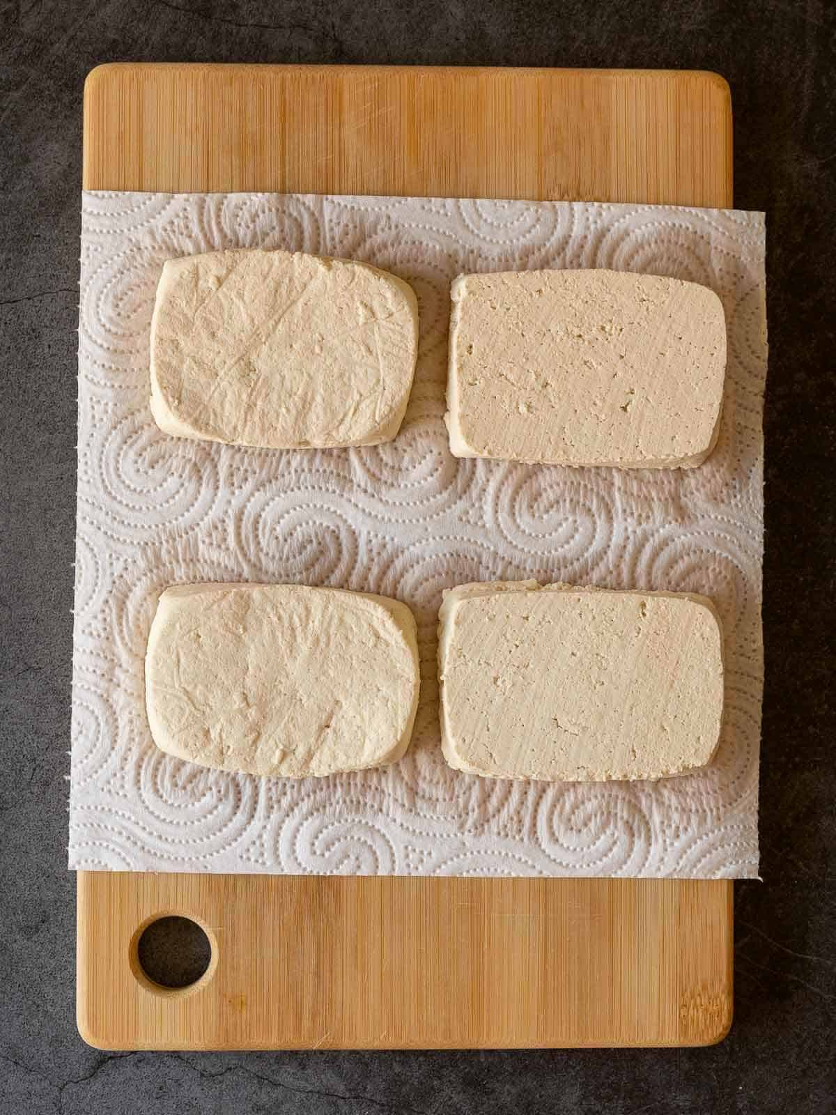 tofu slices on top of paper towels.