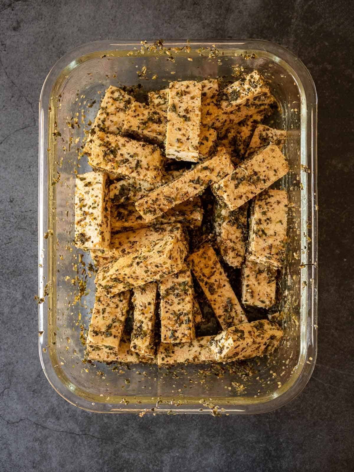 coat tofu strips with marinade.