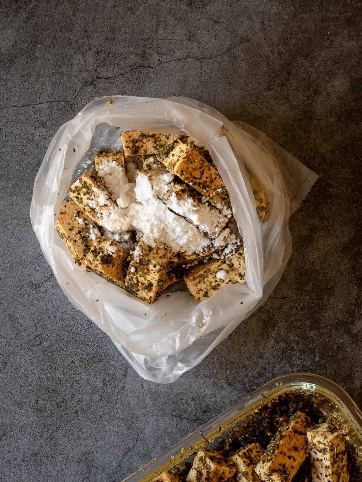 add marinated tofu into a plastic bag and add corn starch until perfectly coated.