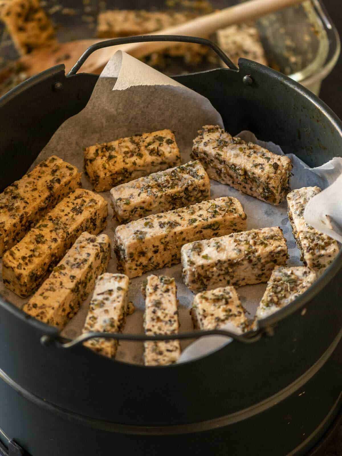 air fry tofu nuggets, separating strips in a single layer.