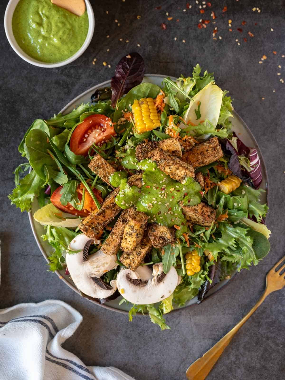 salad with crispy air fryer tofu nuggets on top.