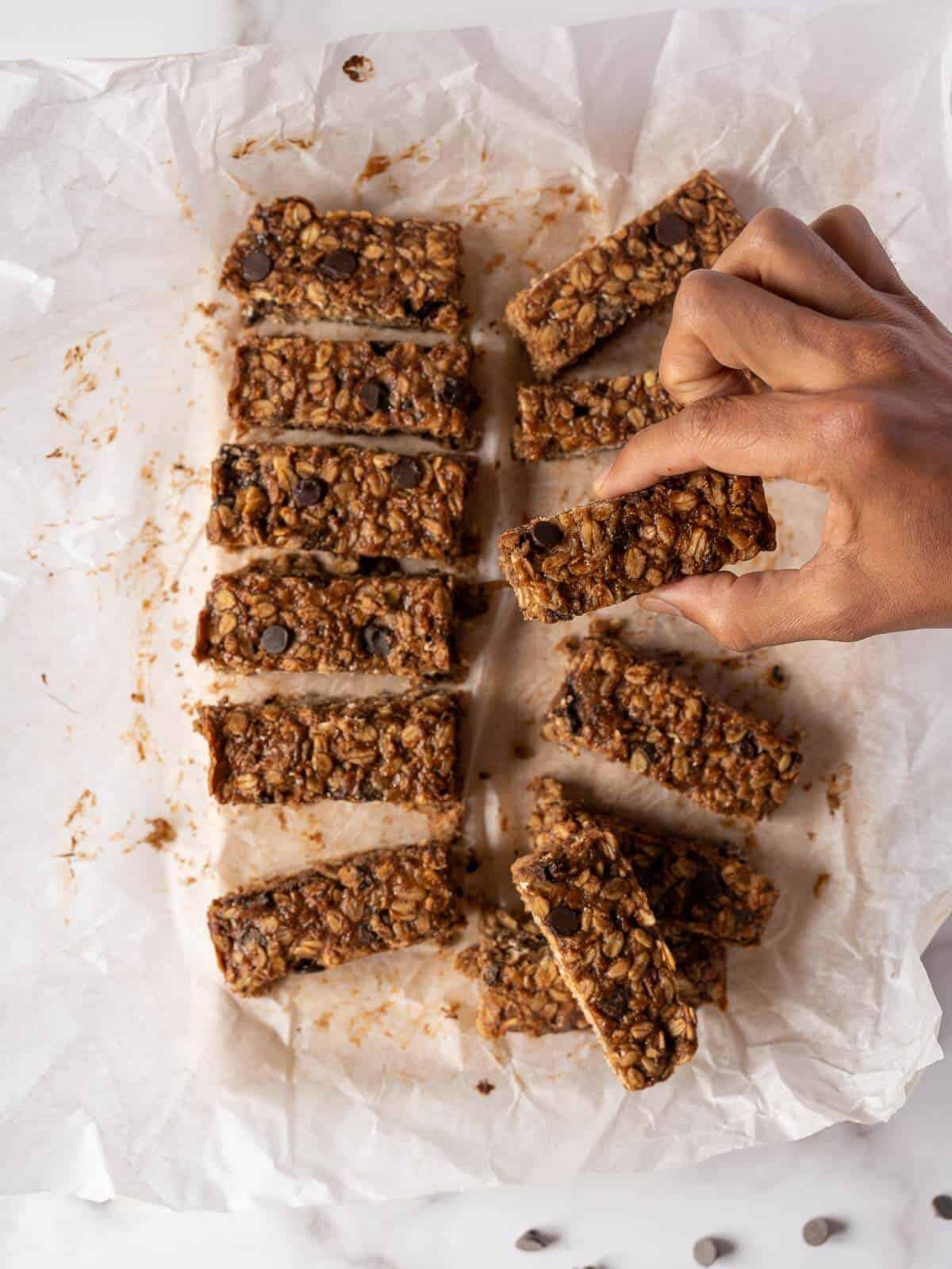 hand picking a chocolate peanut butter oatmeal bar.