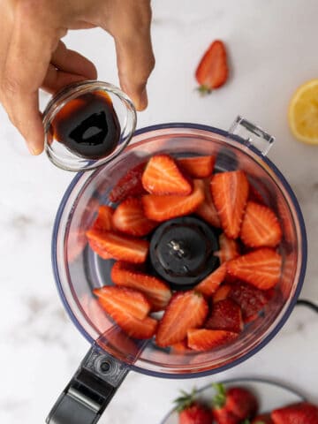 adding thick balsamic vinegar into the food processor.