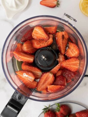 food processor jar with ll the ingredients for the vinaigrette before blending.