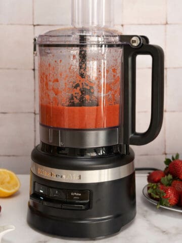 food processor blending ingredients of strawberry balsamic dressing.