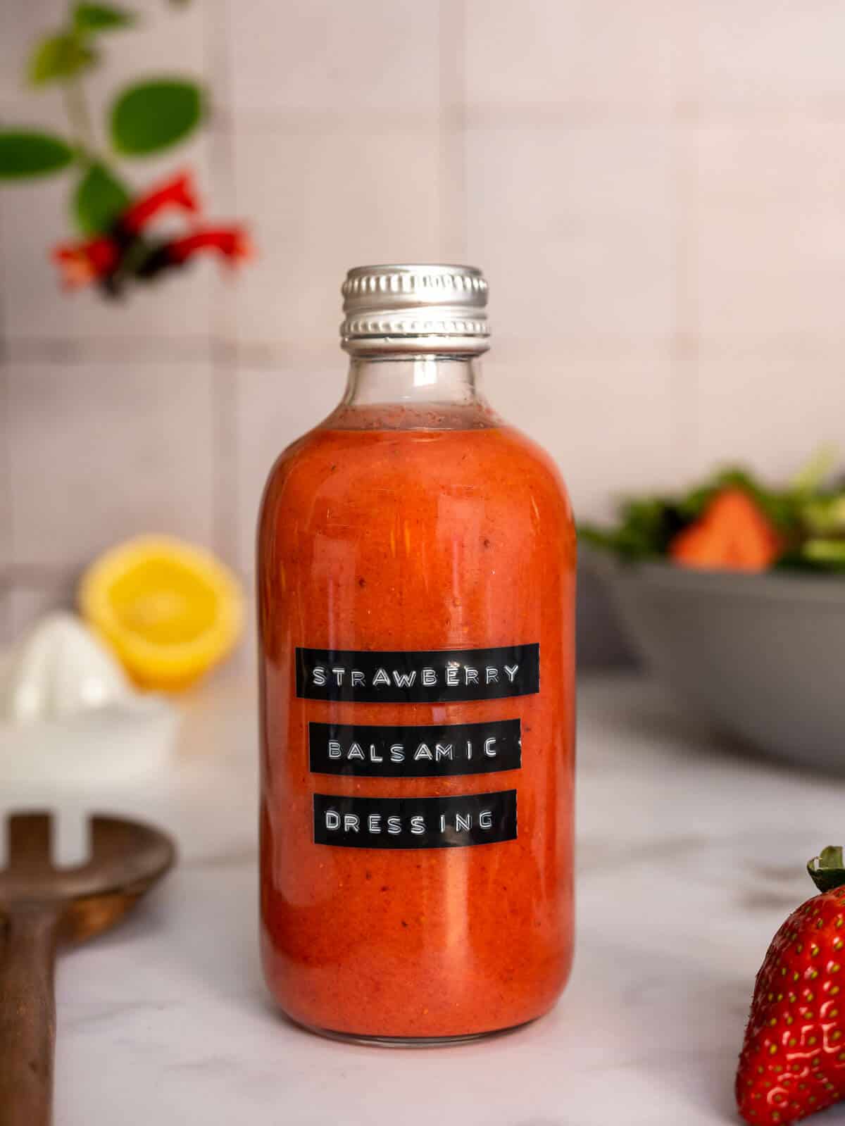 labeled bottle with strawberry balsamic vinaigrette.
