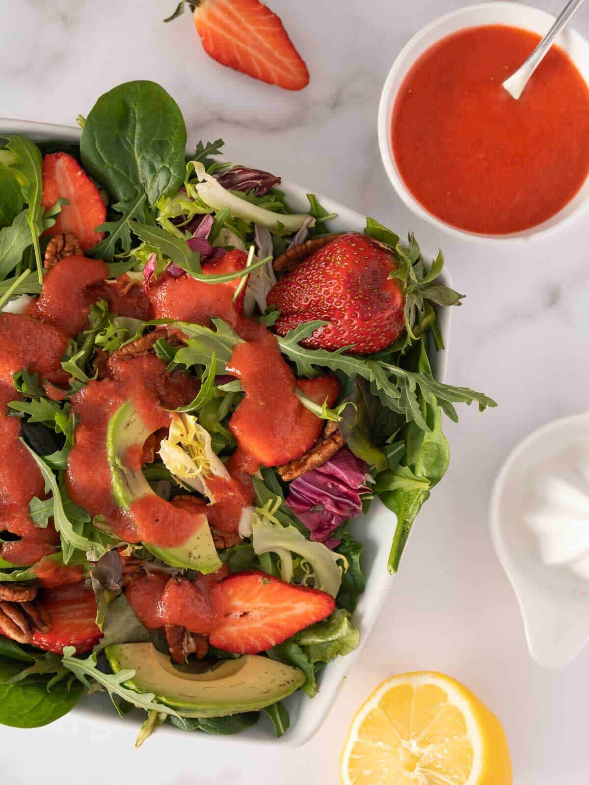 creamy strawberry balsamic dressing over a spinach and arugula salad.