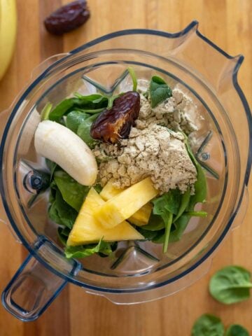 unblended ingredients of pineapple banana smoothie in the blenders' jar.