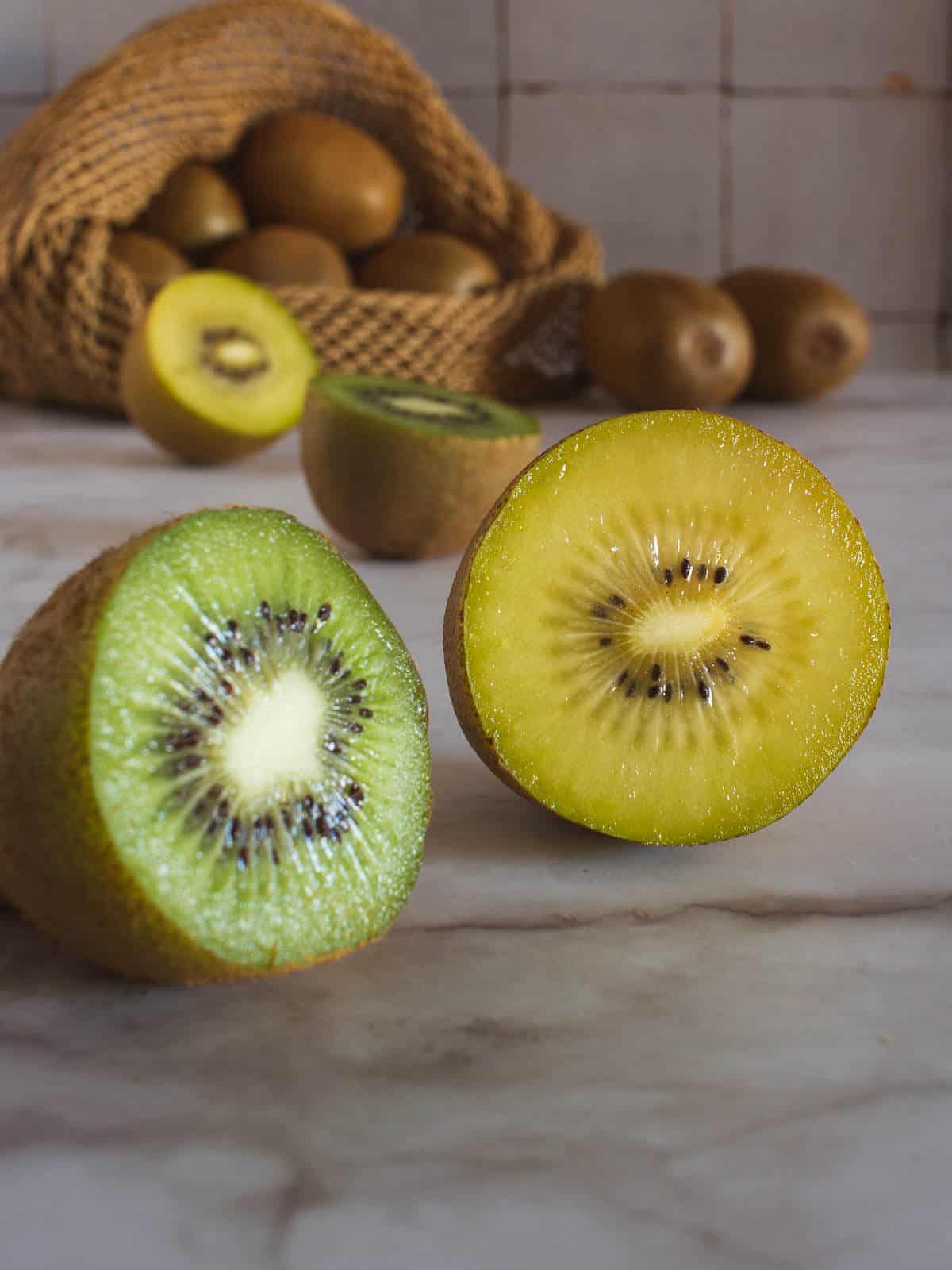 green and yellow kiwi fruits halved.