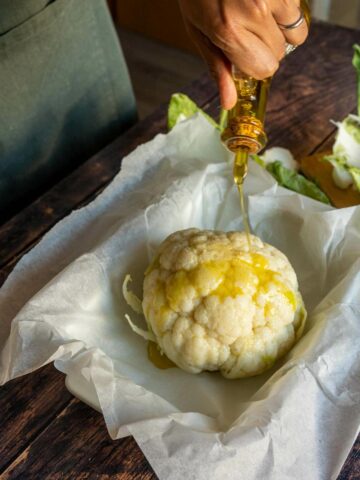 coat the drained cauliflower head with olive oil.