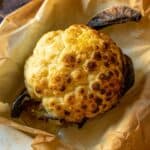 perfectly roasted whole cauliflower head featured.