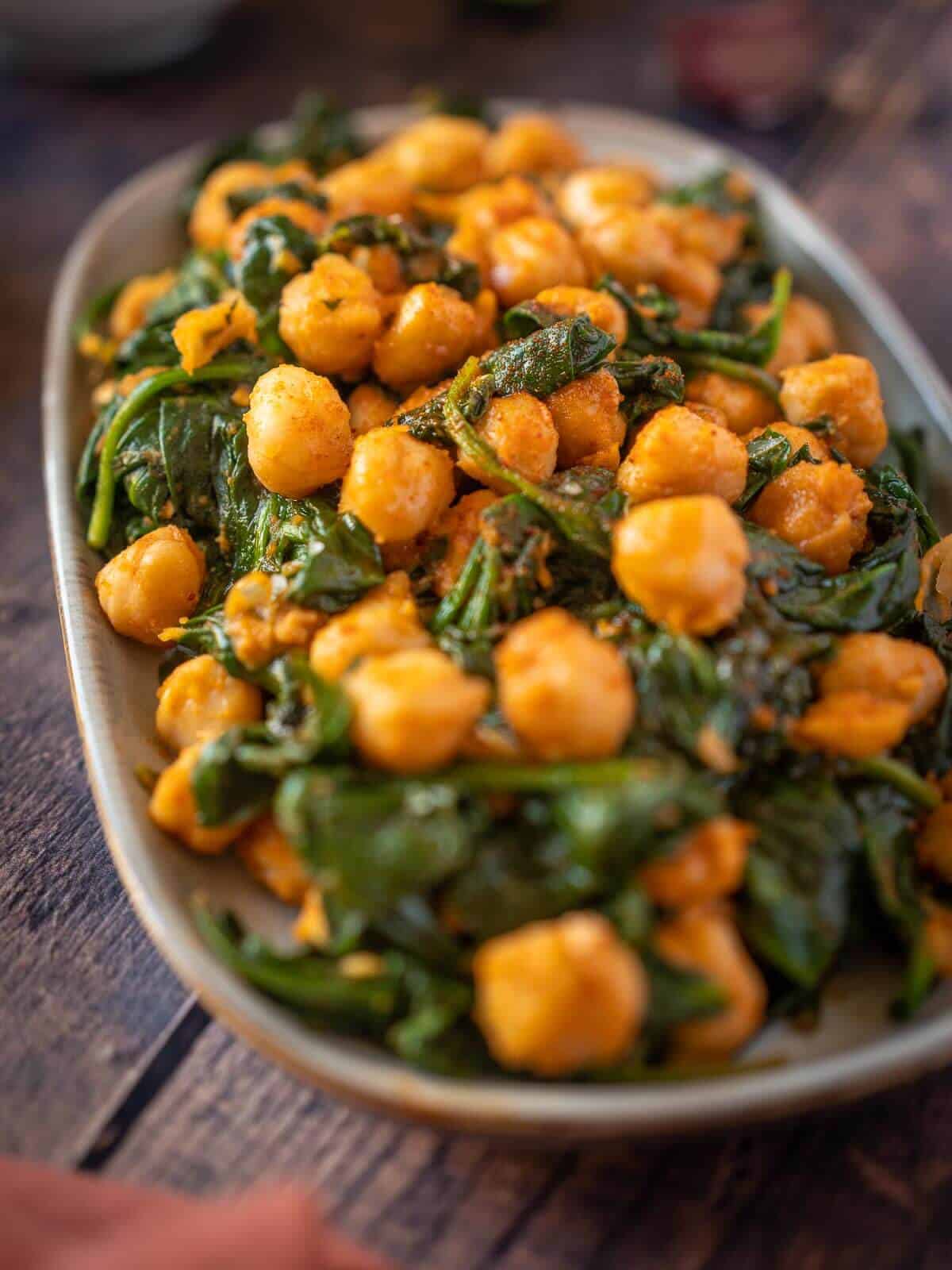 close up of plated spanish sautéed chickpeas with spinach.