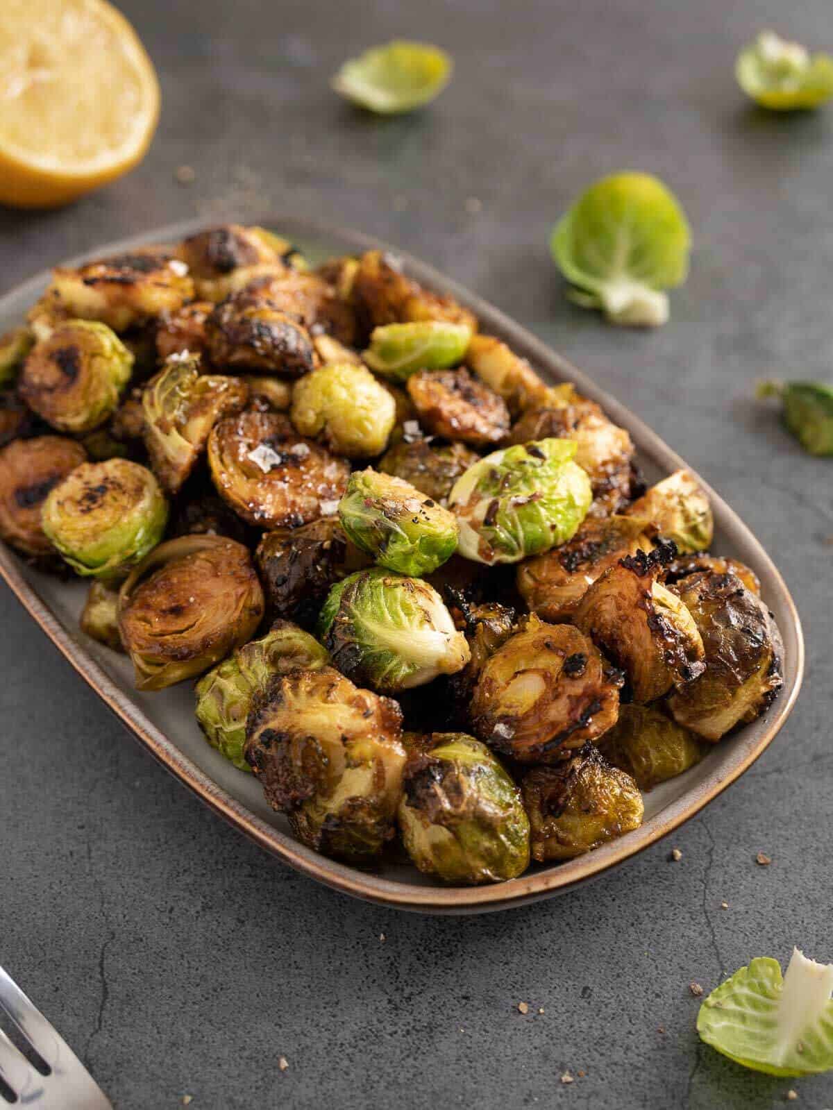 roasted balsamic lemon marinated Brussels spouts side dish plated.