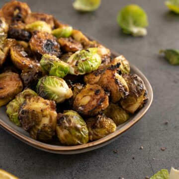 roasted balsamic lemon marinated Brussels spouts side dish plated featured.